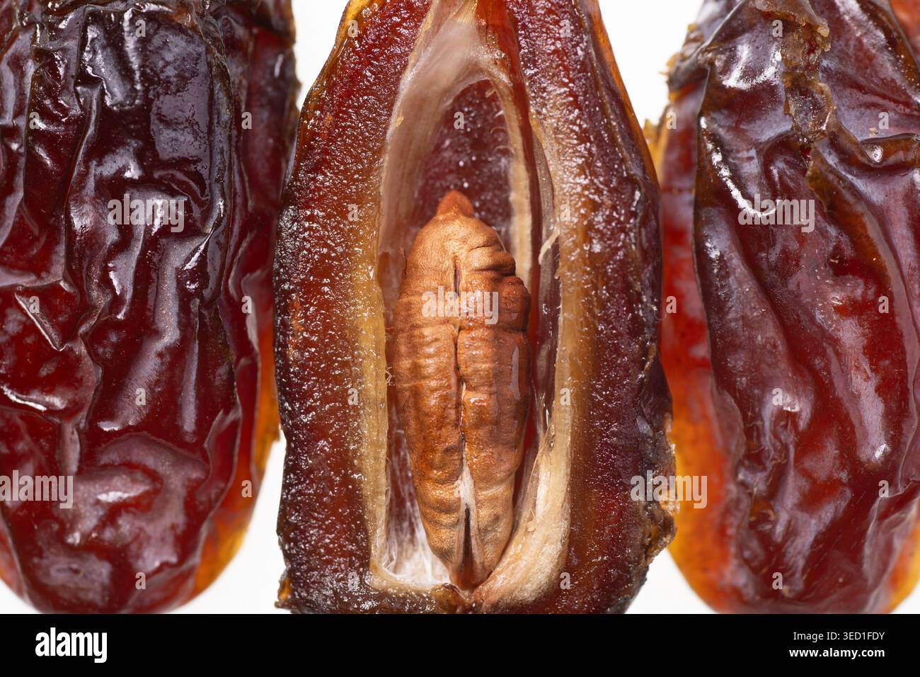 Opened dried dates display seed and textured skin. Stock Photo