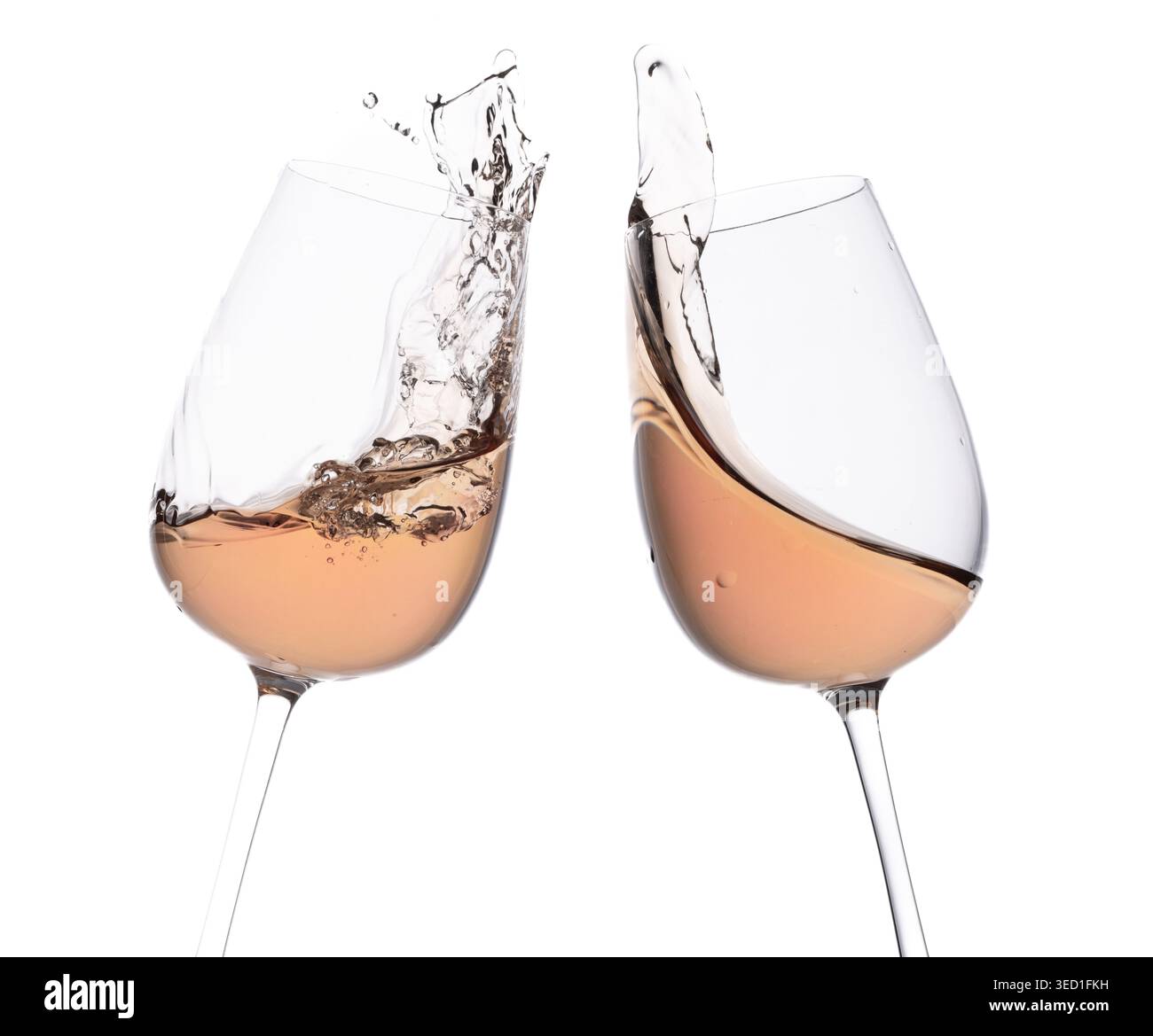 Two glasses clinking filled with rose wine and splash. Stock Photo