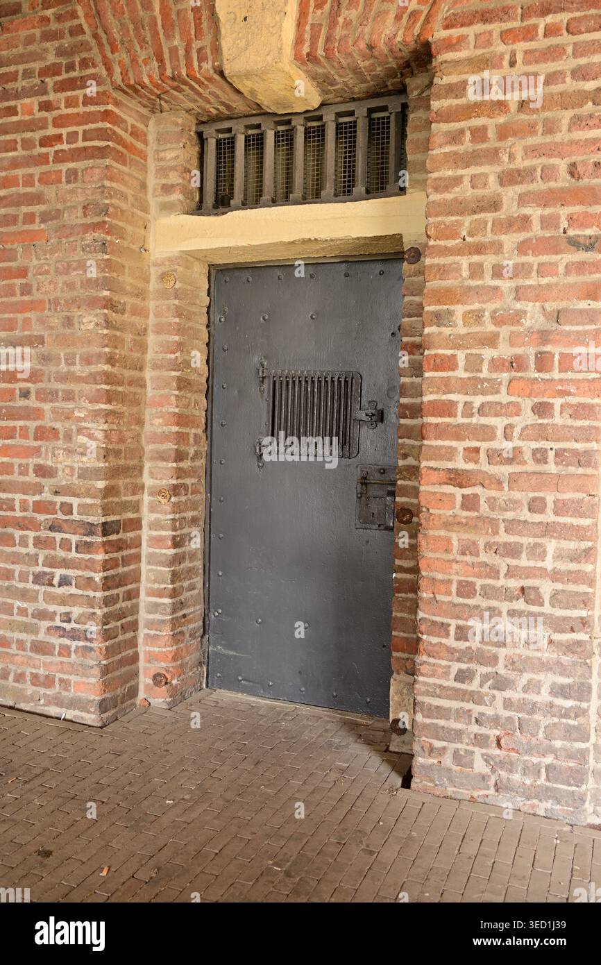 Heavy metal security door in brick wall, German facility Stock Photo
