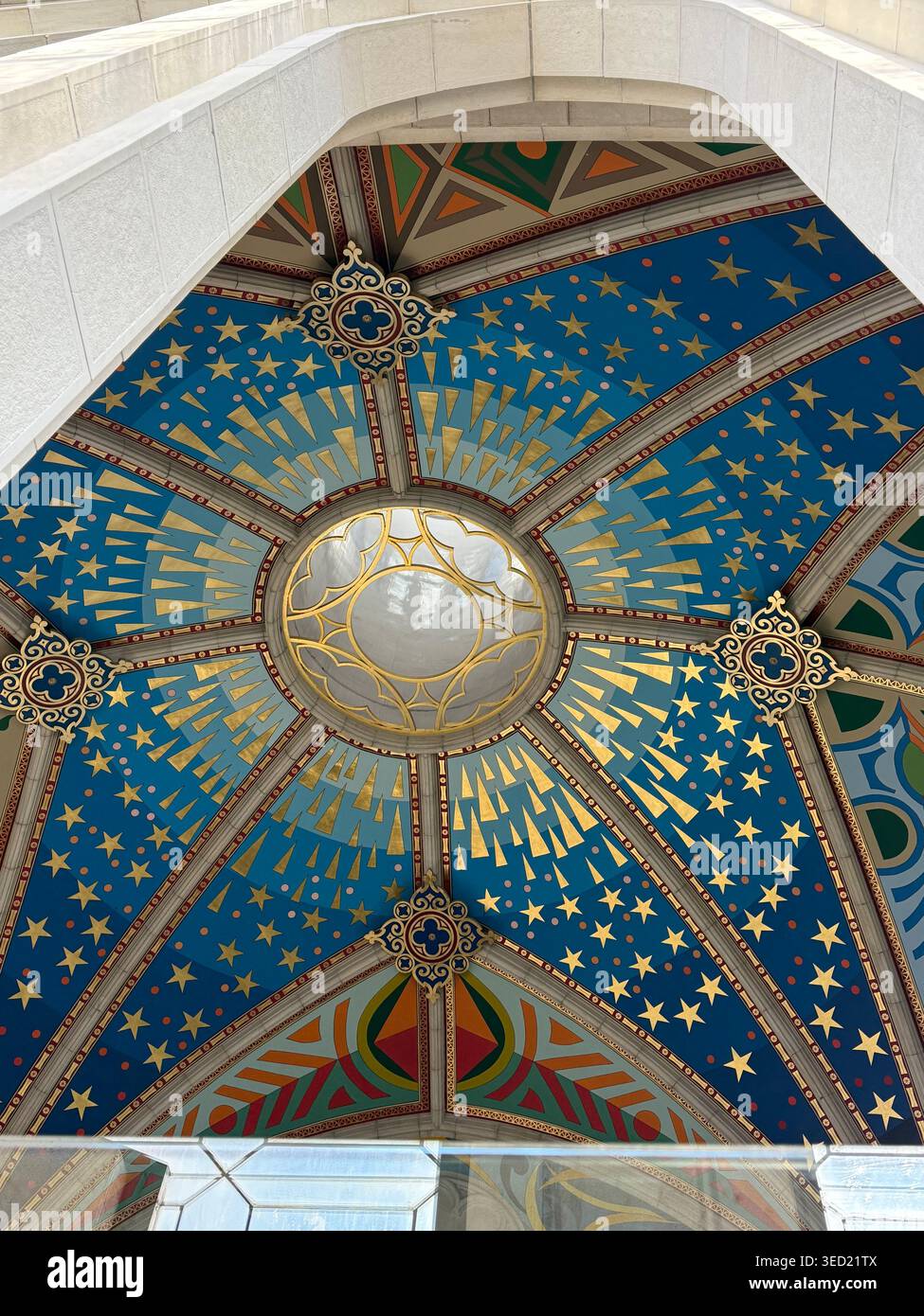 A detailed upward view inside Catedral de Santa María la Real de la Almudena captures the cathedral’s striking blue mosaic cupola and arched ceiling, - Smartphone Captured Stock Image