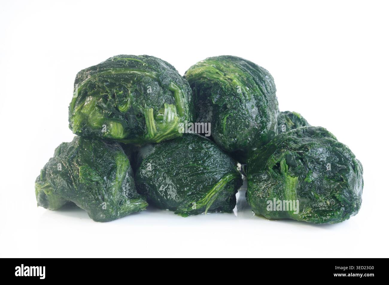 frozen spinach balls on white background Stock Photo