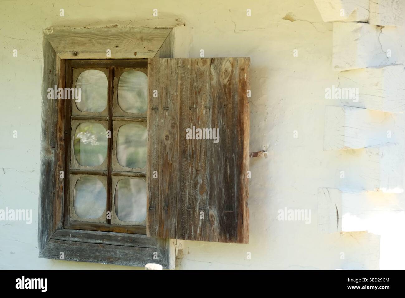Quaint Window A weathered window stands open, revealing a quaint scene from the ...