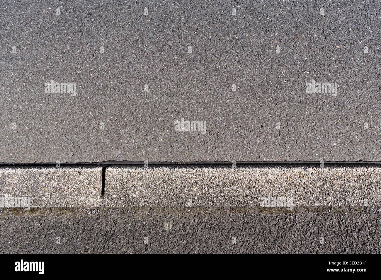 paved road surface and concrete curb Stock Photo