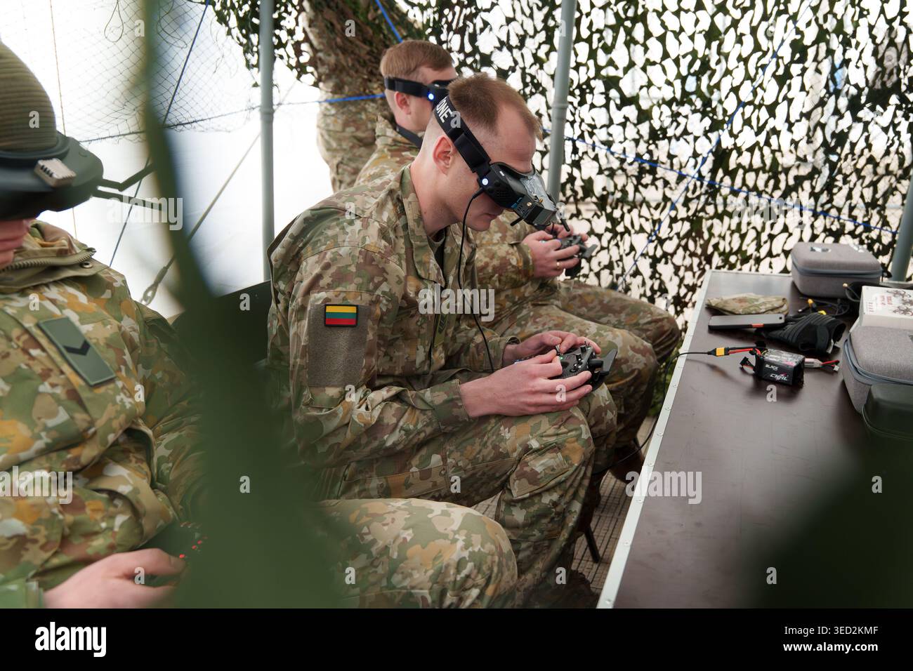 Soldiers in camouflage uniforms using FPV goggles and remote ...