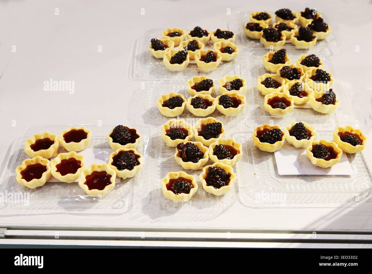Shell Pastries Menu Golden pastry shells cradle rich, glossy preserves. Bright lighting ...