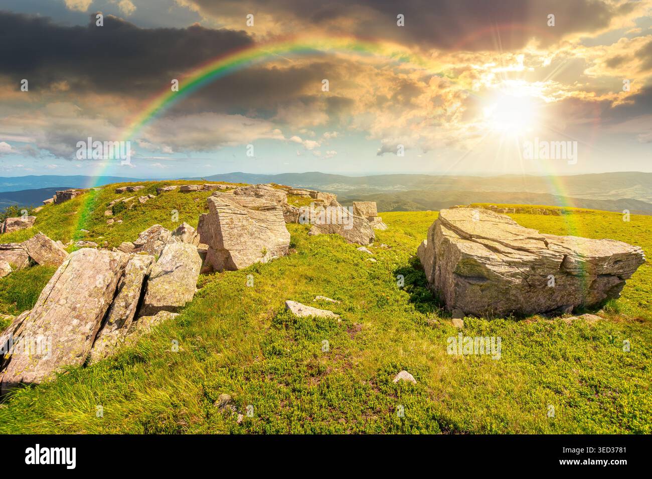 sunset over mountainous landscape during summertime. boulders and rock formations surrounded grassy hills. picture of an untouched highland. leadershi Stock Photo