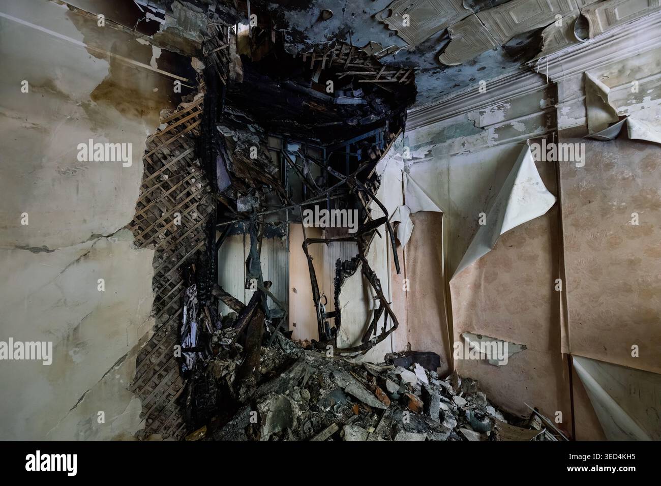 Damaged wall aftermath of explosion and fire after attack. Stock Photo