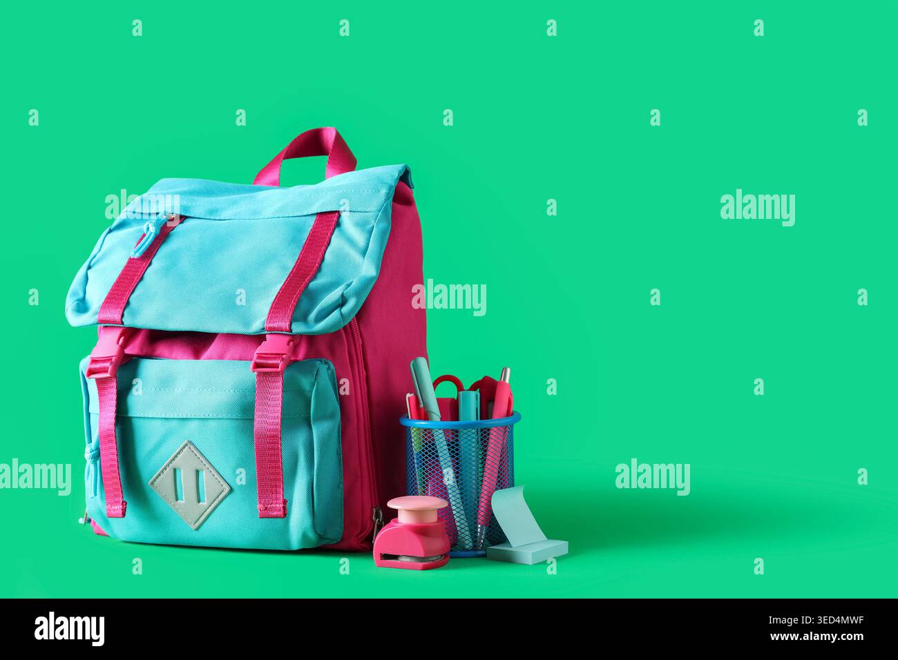 Stylish school backpack and different stationery on green background Stock Photo