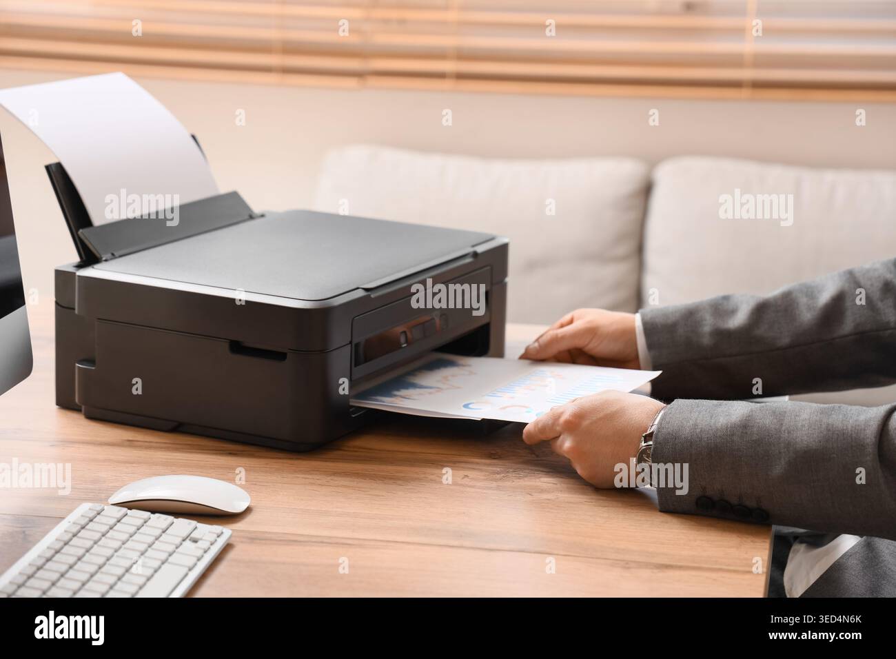 Male hands using printer on desk in office Stock Photo