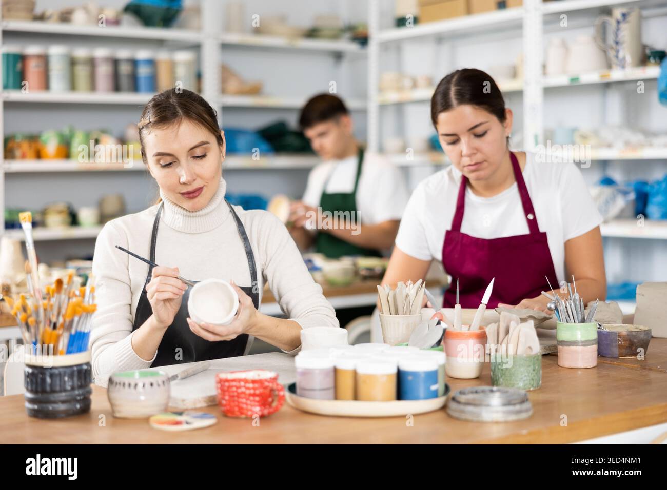 Two young women making pottery in workshop Stock Photo