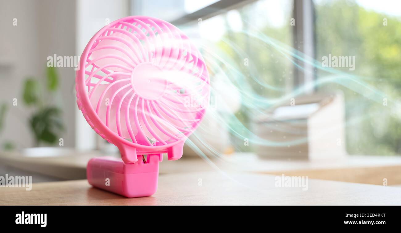 Pink mini fan on table, closeup Stock Photo