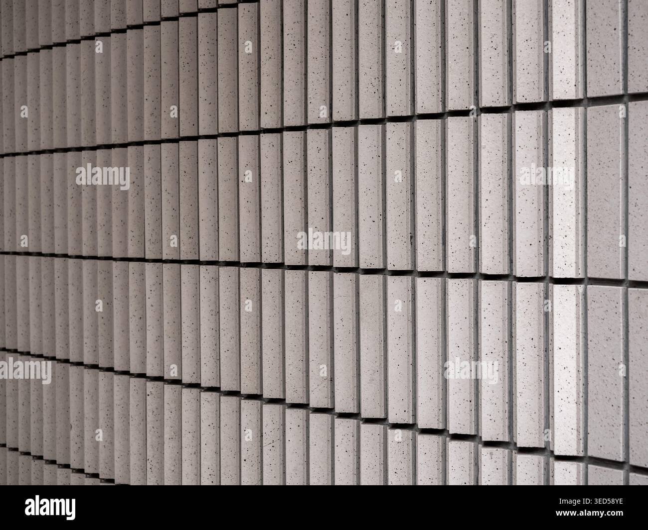 Abstract ceramic tile wall texture with repeating geometric pattern and clean architectural lines. Minimal modern surface design creating rhythmic str Stock Photo
