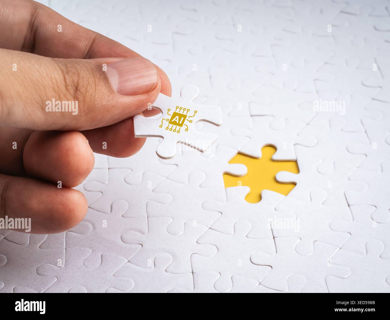 Hand placing AI puzzle piece into missing spot on white jigsaw background. Artificial intelligence solving problems, innovation, business solution, te Stock Photo