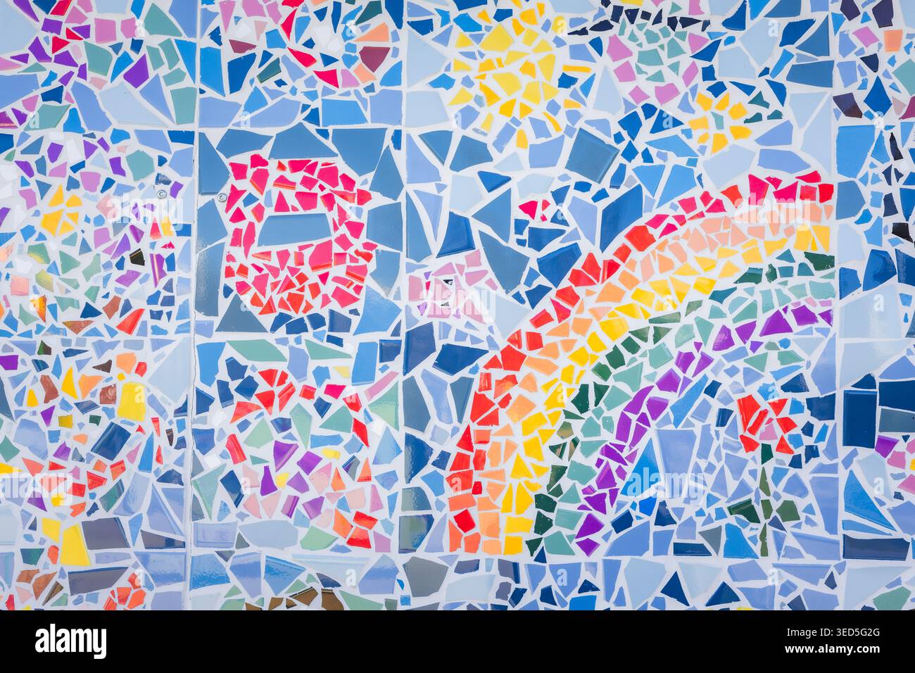 Colorful abstract ceramic mosaic. Close up. Mosaic on the wall with fragments of blue, white, black colors with pieces. Stock Photo