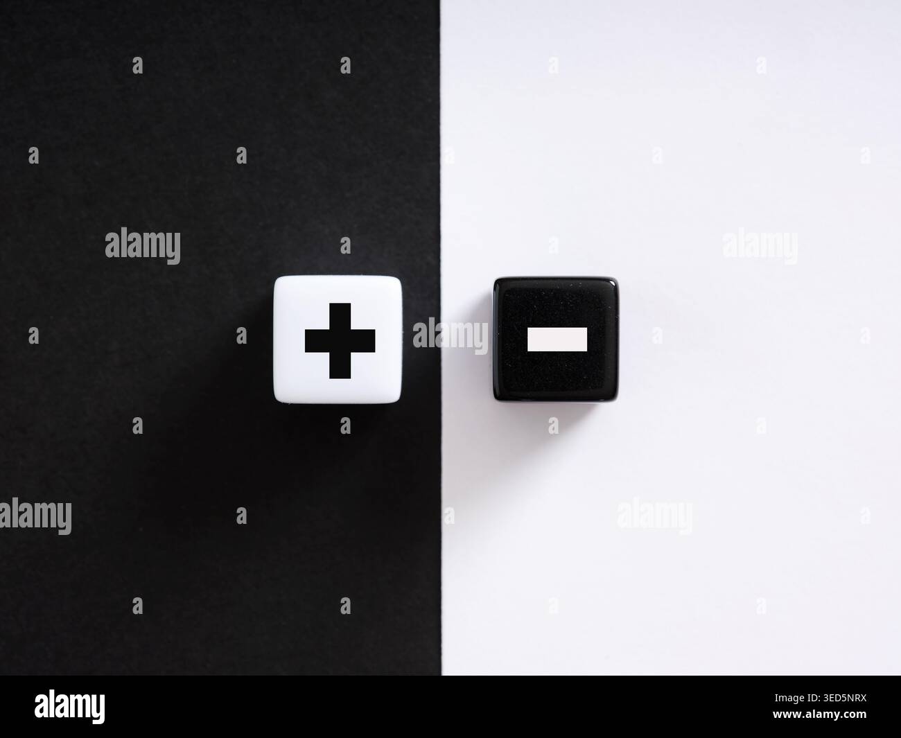 Plus Sign Dice White dice showing plus sign and black dice showing minus sign laying ...