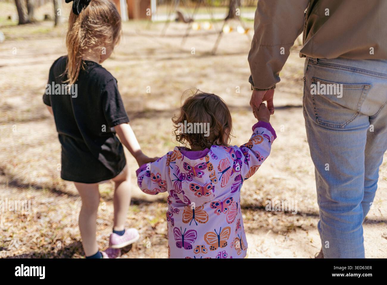 Two Children walking to the park with their father Stock Photo - Alamy