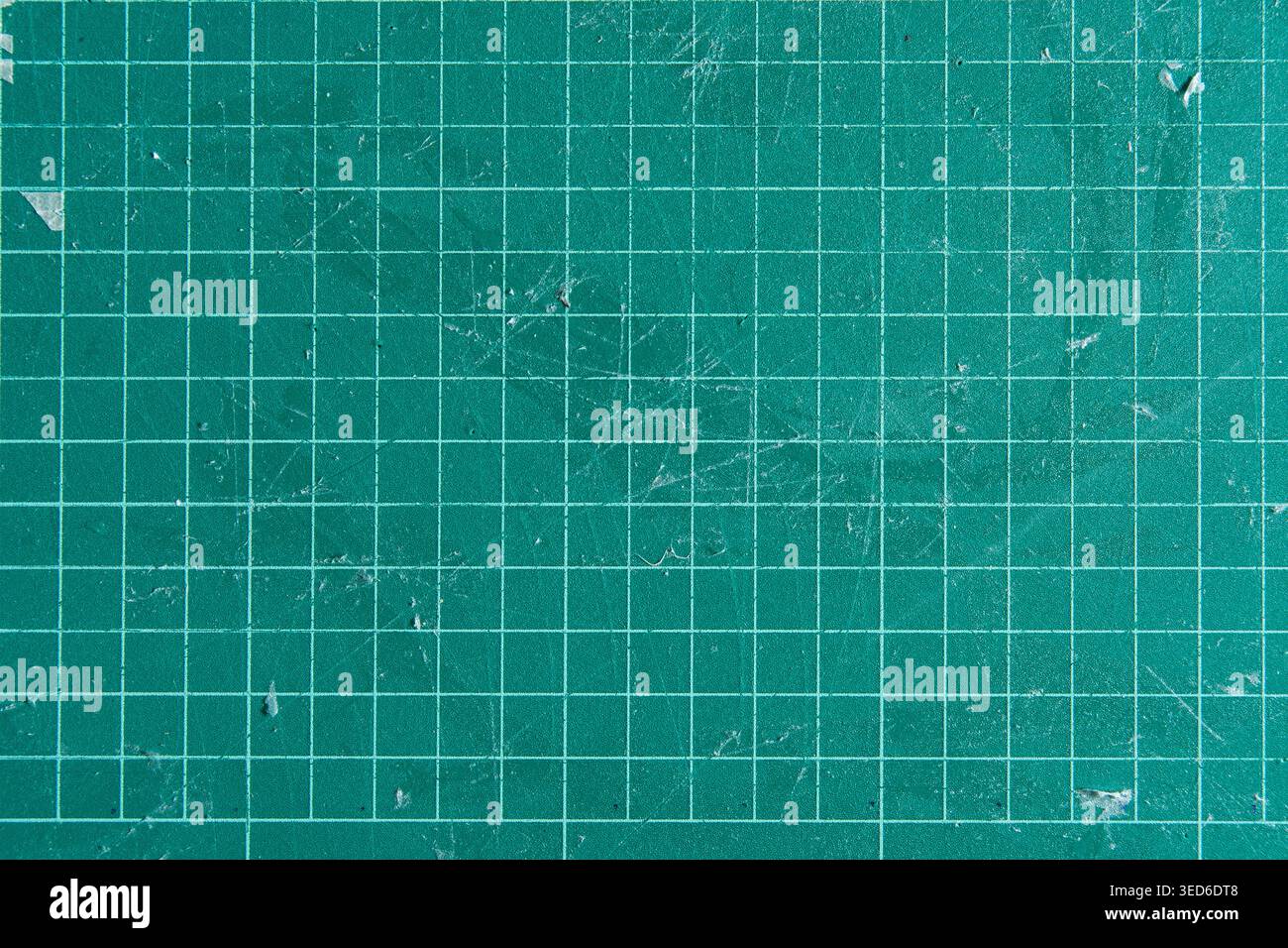 Worn Green Self Healing Cutting Mat Background with Grid Lines and Scratches Stock Photo