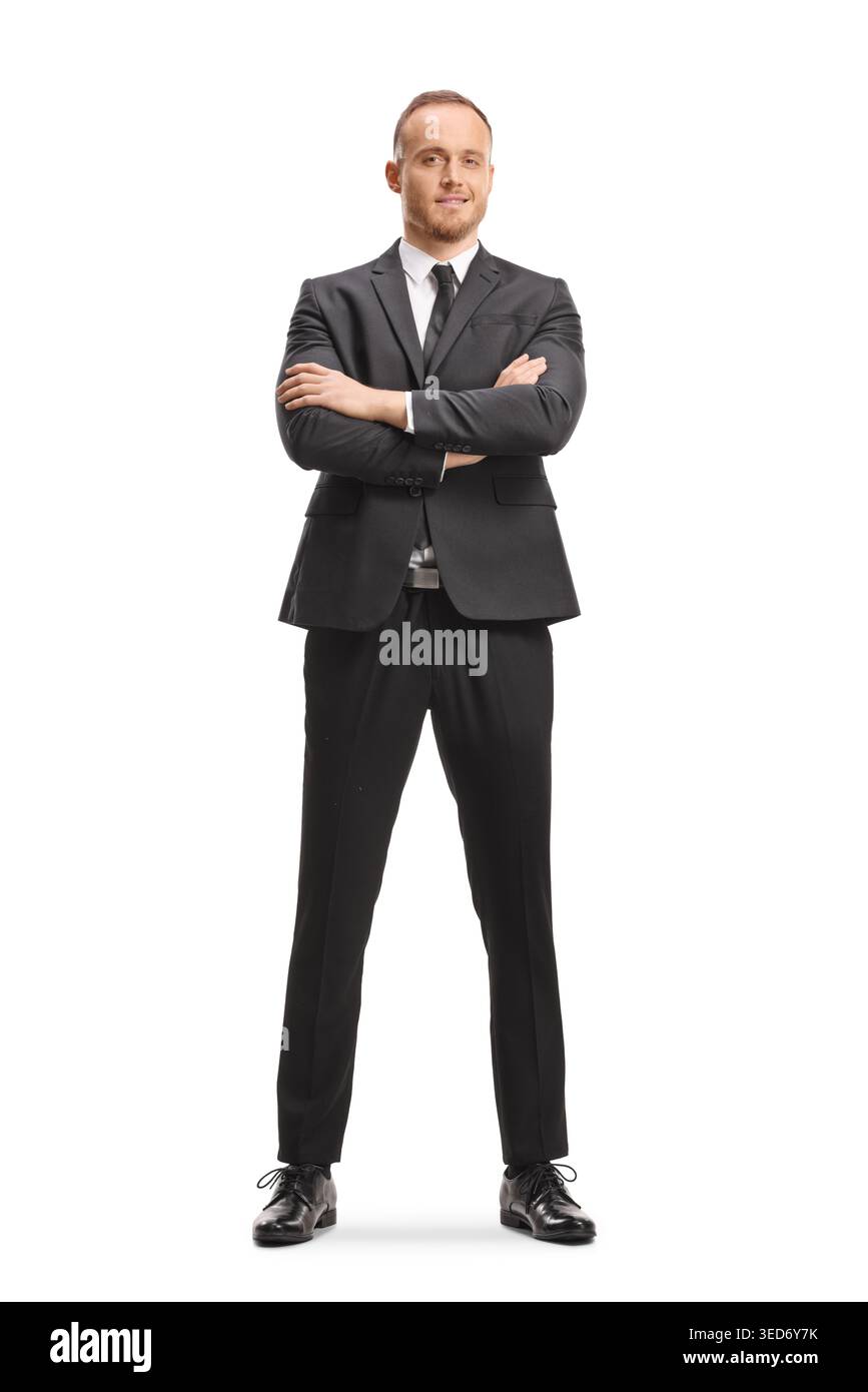 Young man in a black suit with crossed arms isolated on white background Stock Photo