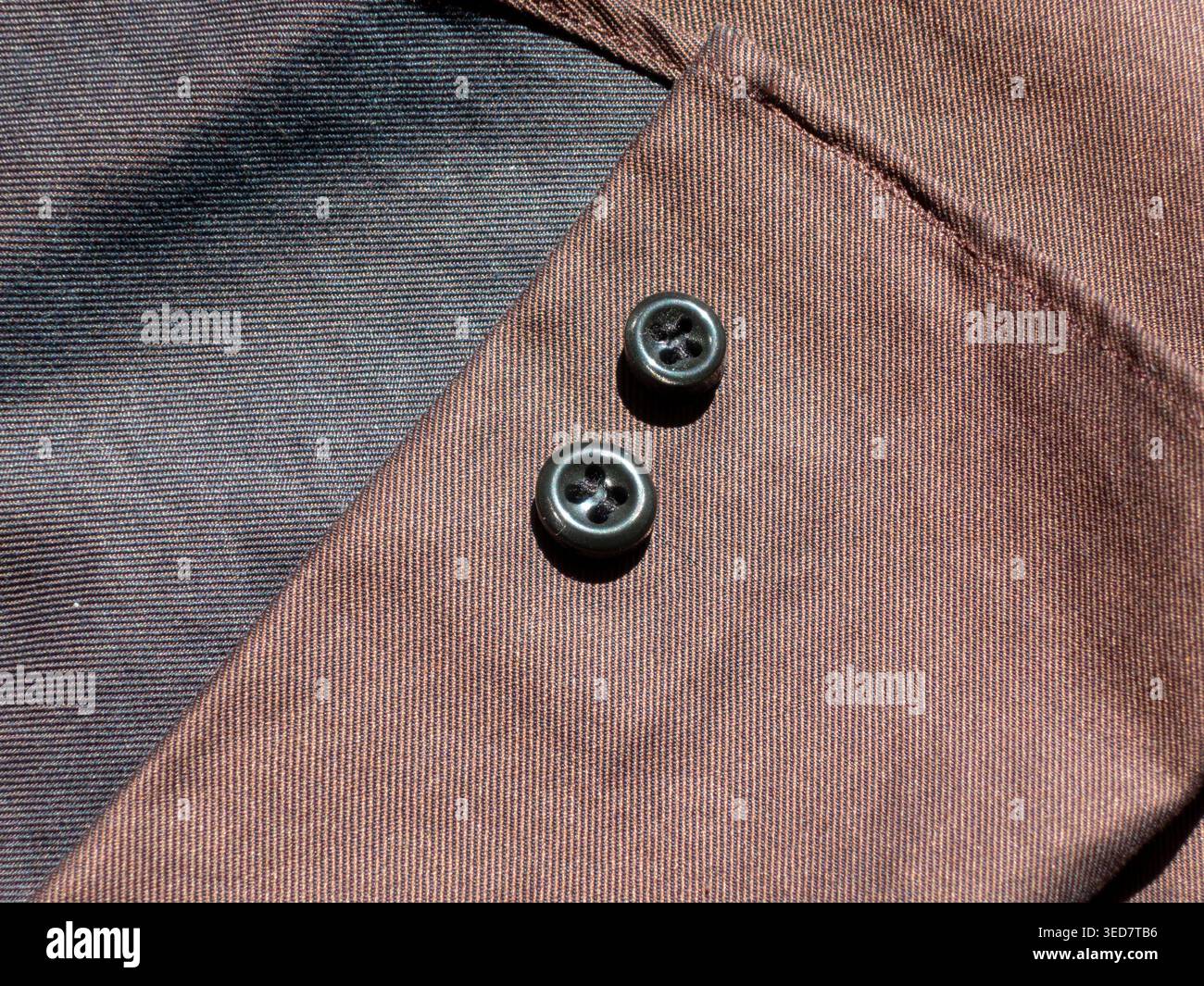 Black buttons on brown fabric macro bacground Stock Photo