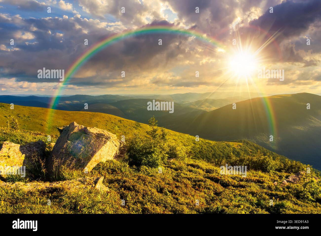 sunset over Carpathian mountain summer landscape. meadow with huge stones among the grass on top of the hillside near the peak of mountain range. alpi Stock Photo