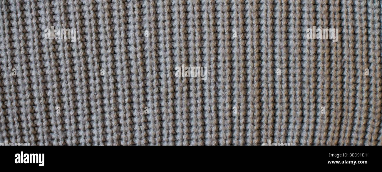 Gray knitted textile showing a textured waffle weave. Pattern and background Stock Photo