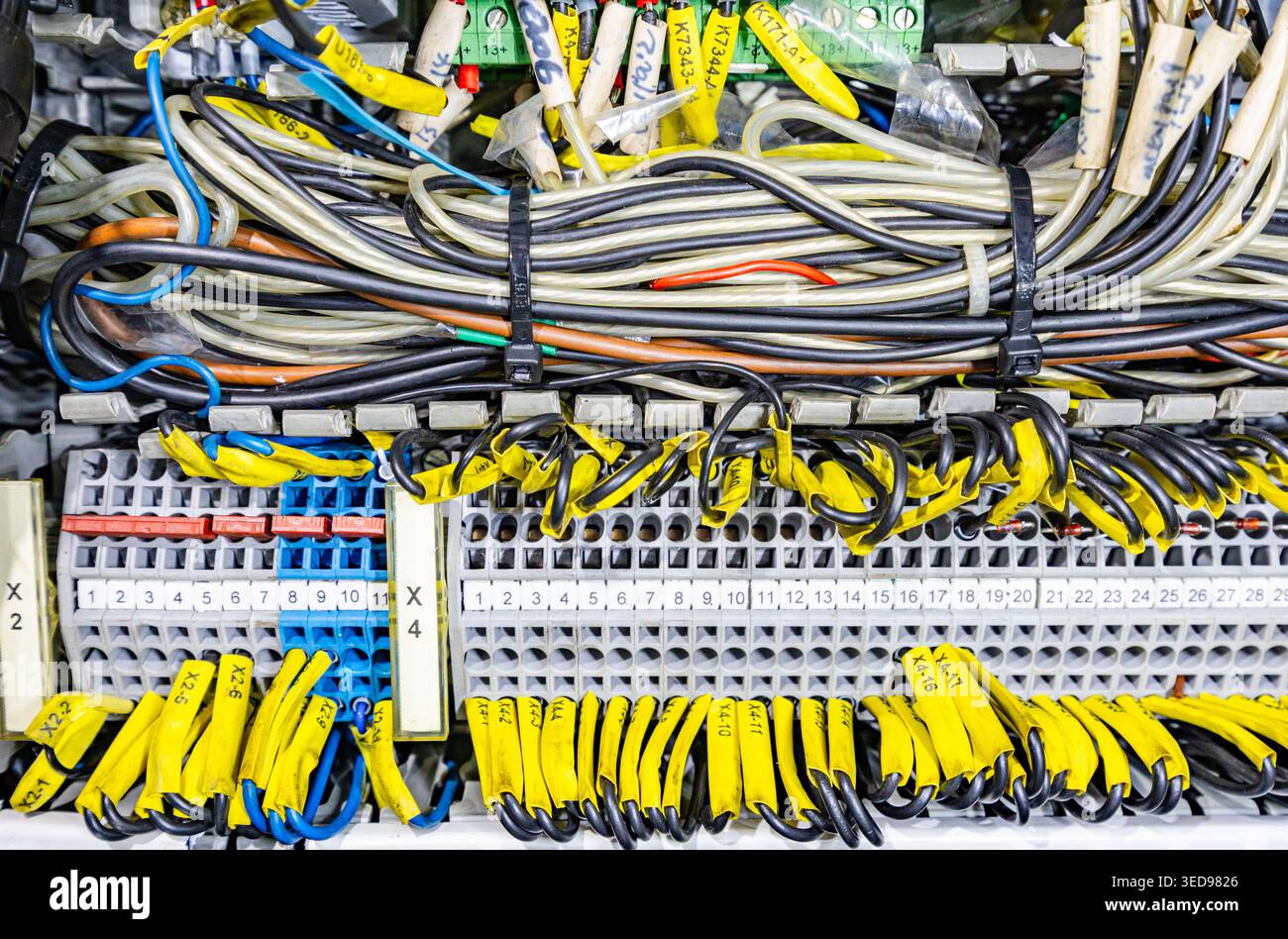 Control Labelled Complex industrial electrical control panel with many labeled yellow ...