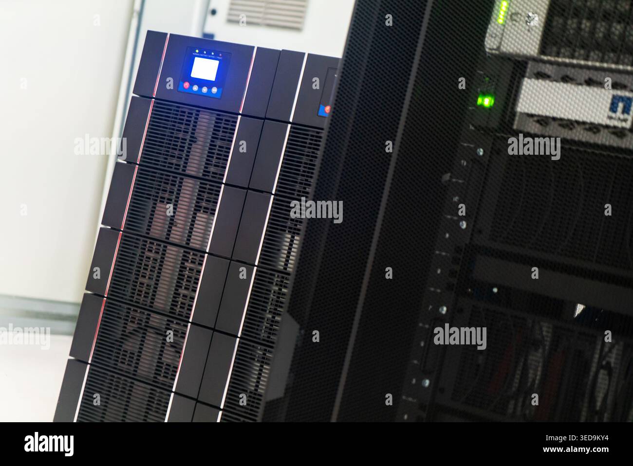 This image showcases a high-tech server rack in a modern data center, emphasizing the advanced technology used for data processing and storage solutio Stock Photo
