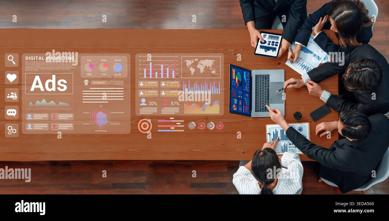 A diverse team of professionals collaborates in a modern office setting, utilizing technology and analytics to strategize effective digital marketing Stock Photo