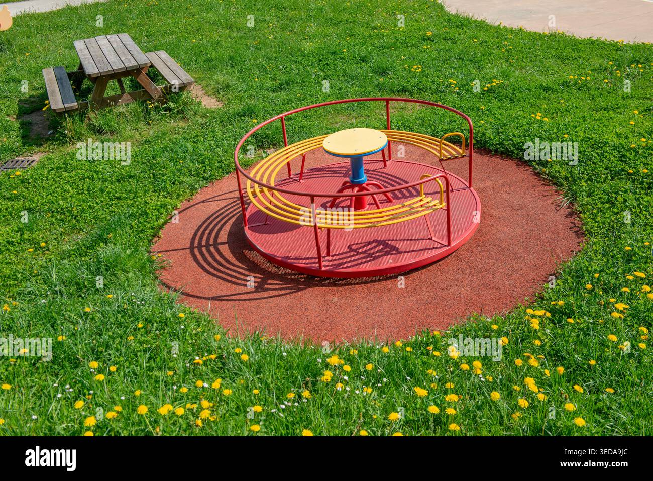 Children's carousel in the park in bloom in spring Stock Photo - Alamy