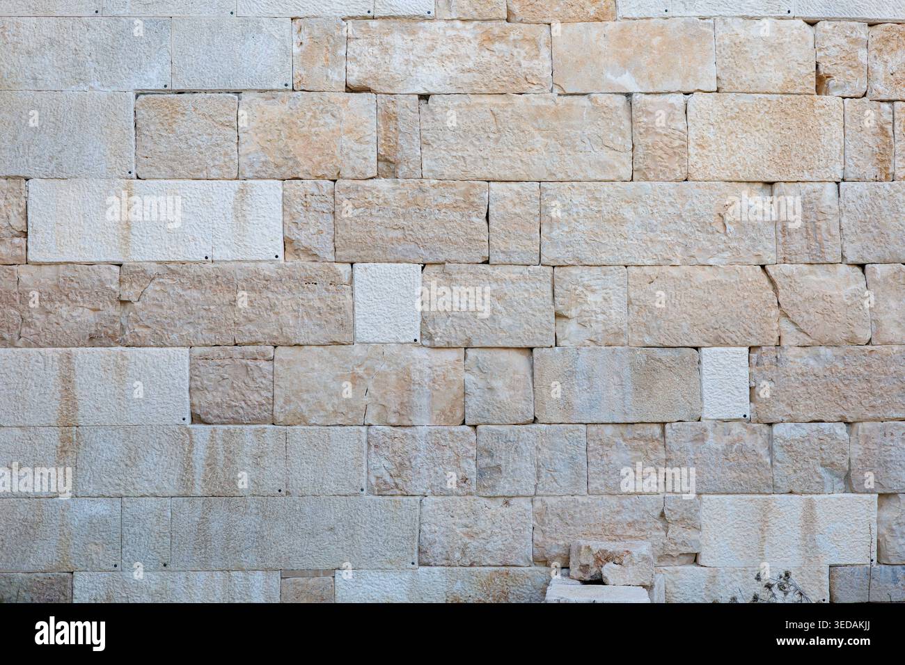 Natural stone wall texture with rectangular blocks in warm earth tones Stock Photo