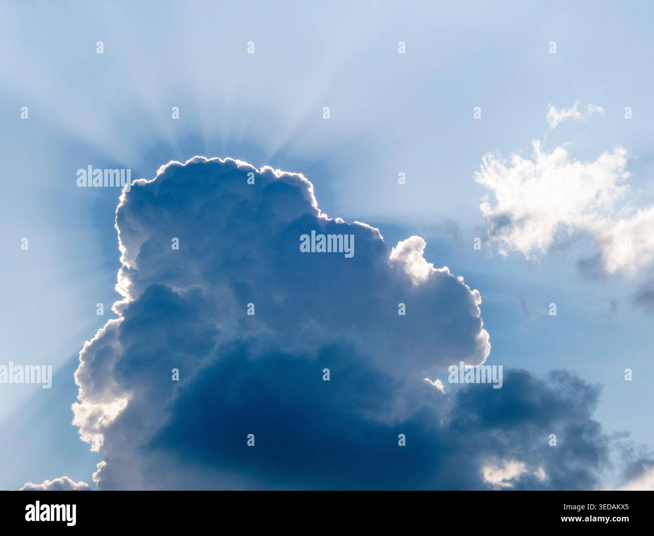 Sun shines from behind a cloud landscape Stock Photo
