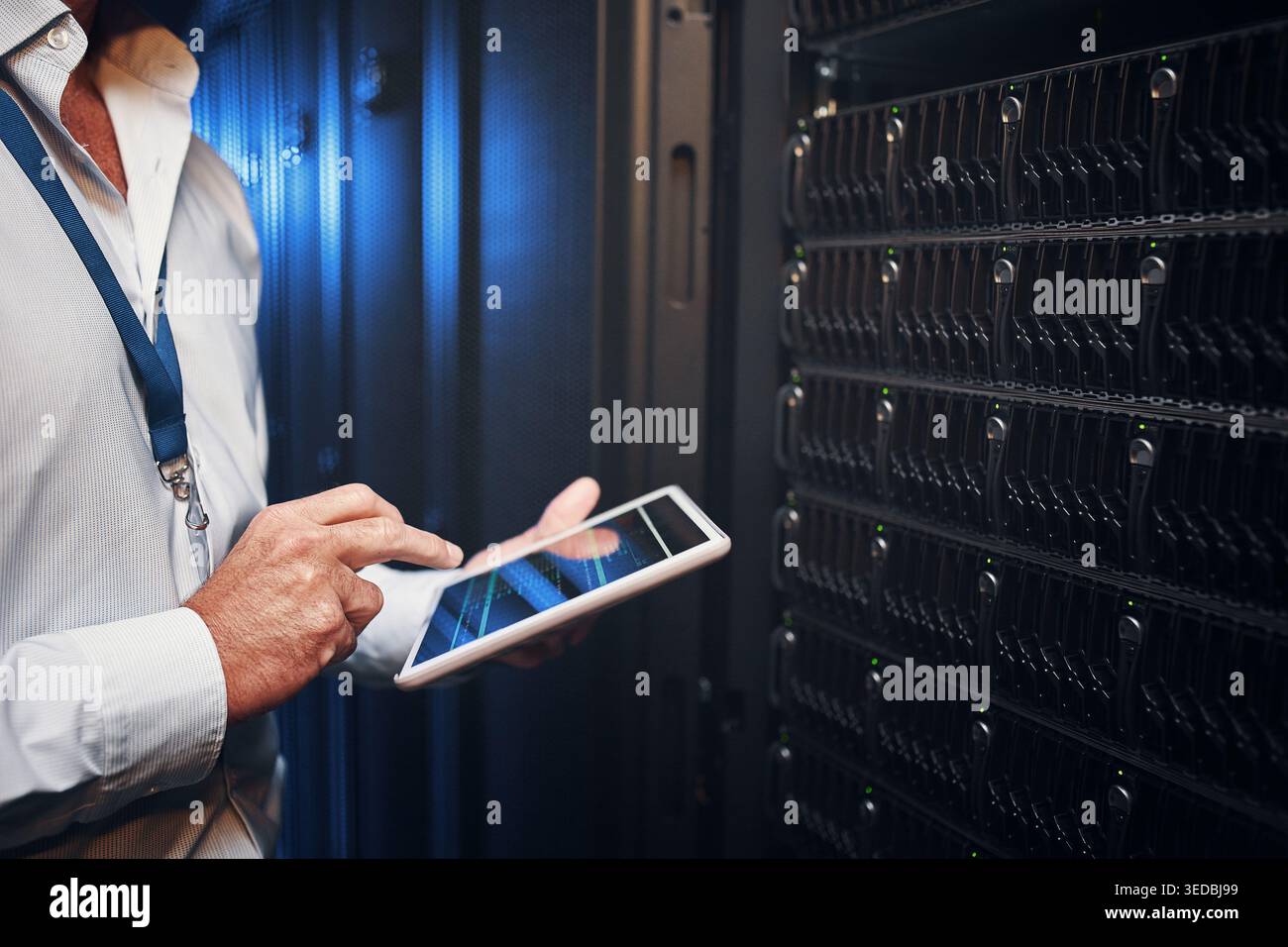 Engineer, hands and tablet screen in server room for maintenance, diagnostic code or IT support. Network technician, man and tech in data center for Stock Photo