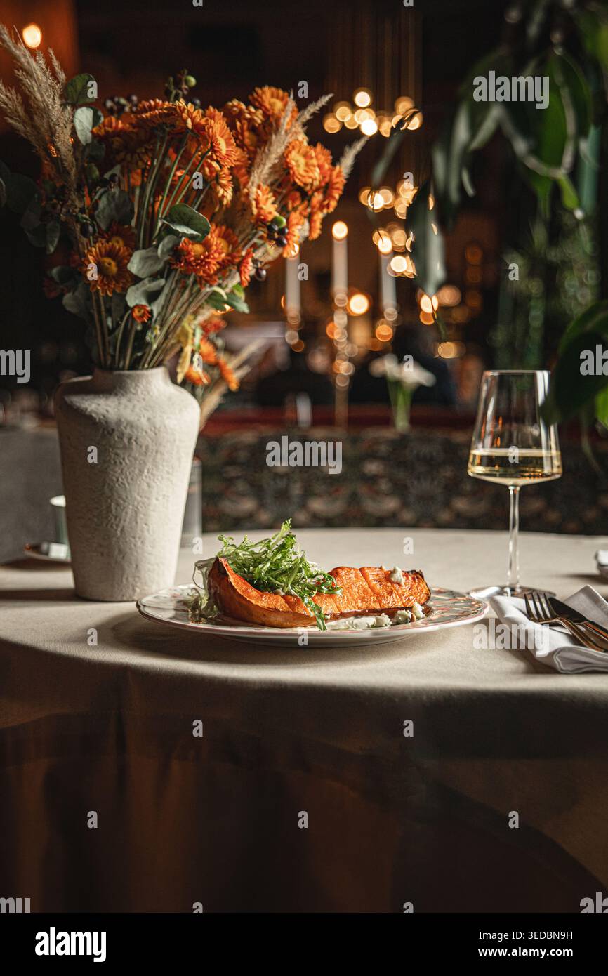Baked pumpkin served on elegant restaurant table Stock Photo