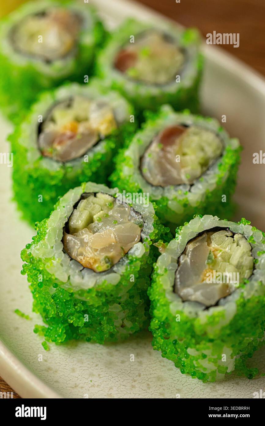 Sushi rolls with green coating and ginger Stock Photo