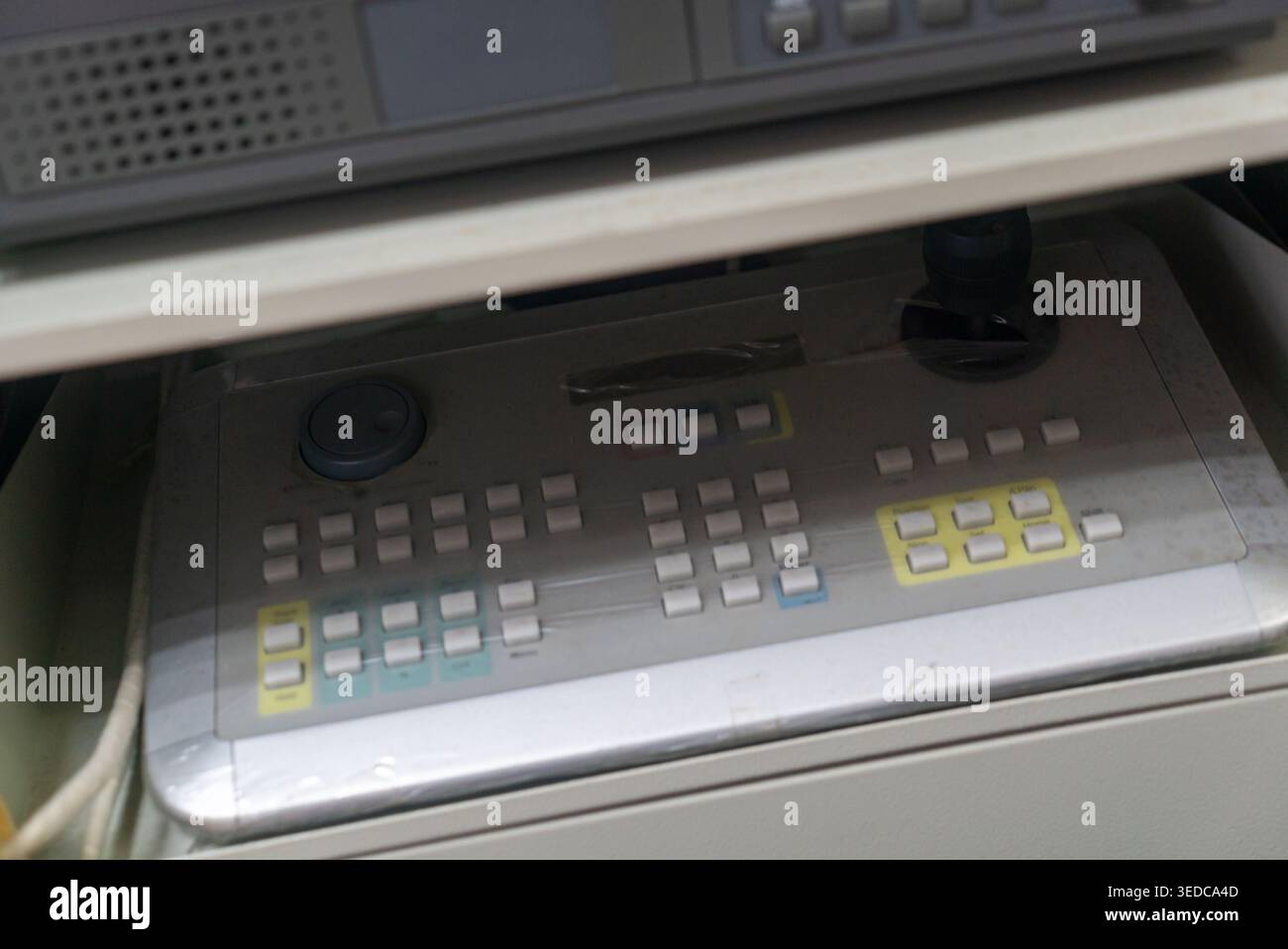 This image captures a control panel featuring an array of buttons and knobs, showcasing a modern interface designed for precise operation in various e Stock Photo