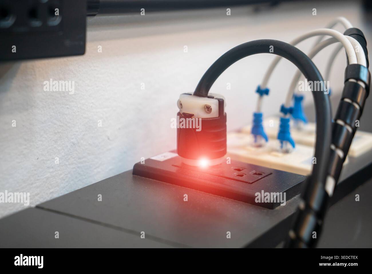 A detailed view of a power outlet featuring an indicator light ...