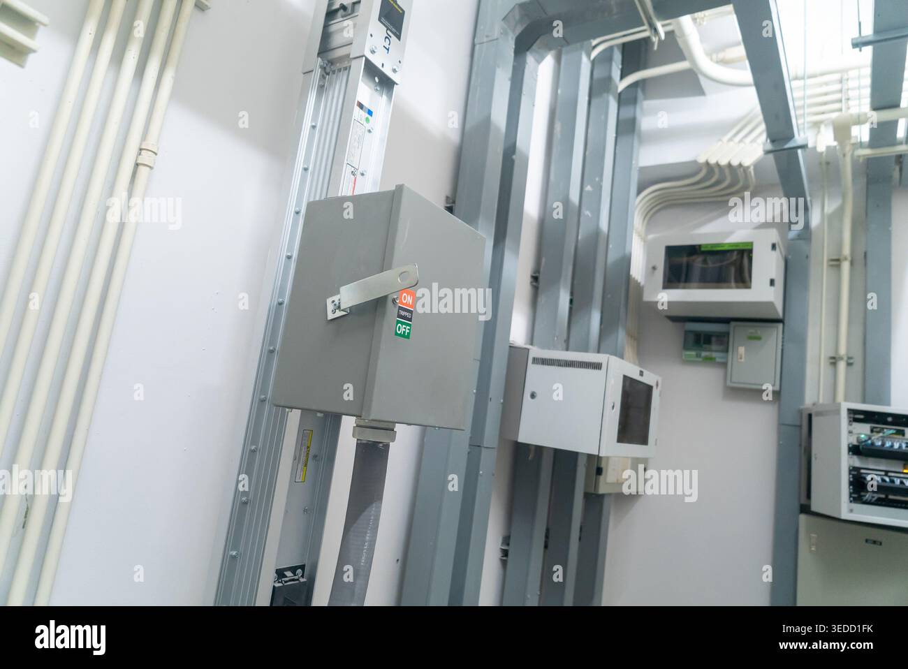 A detailed view of an electrical control room featuring various panels ...