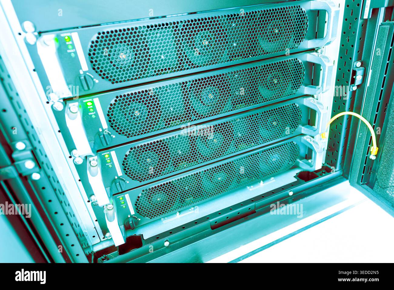 This image showcases a high-tech server rack featuring multiple cooling fans, essential for optimal data processing and storage in modern IT infrastru Stock Photo