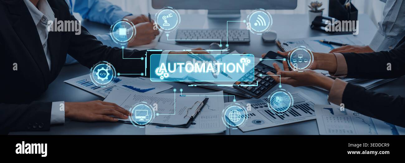 A business team works together in a modern office setting, focusing on strategies for automation while integrating various digital tools and icons to Stock Photo