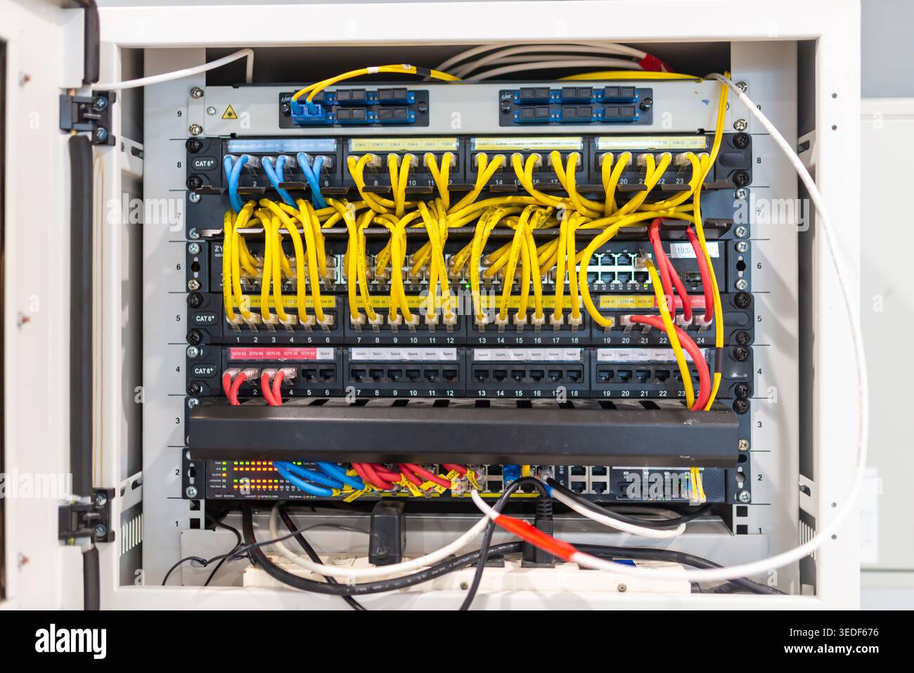 A detailed view of a network hub featuring colorful cables. This image ...