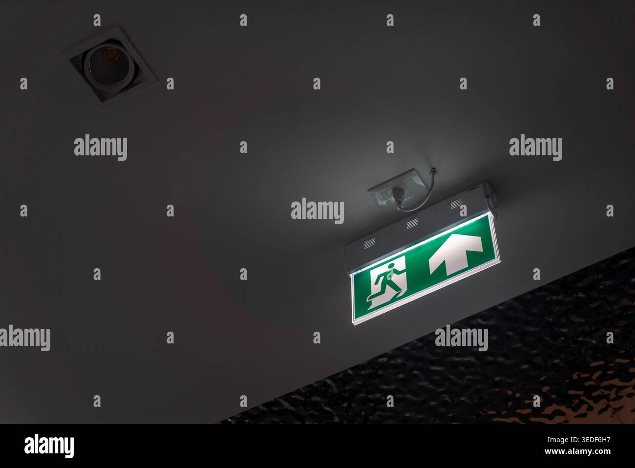 A vibrant exit sign mounted on the ceiling, providing clear ...