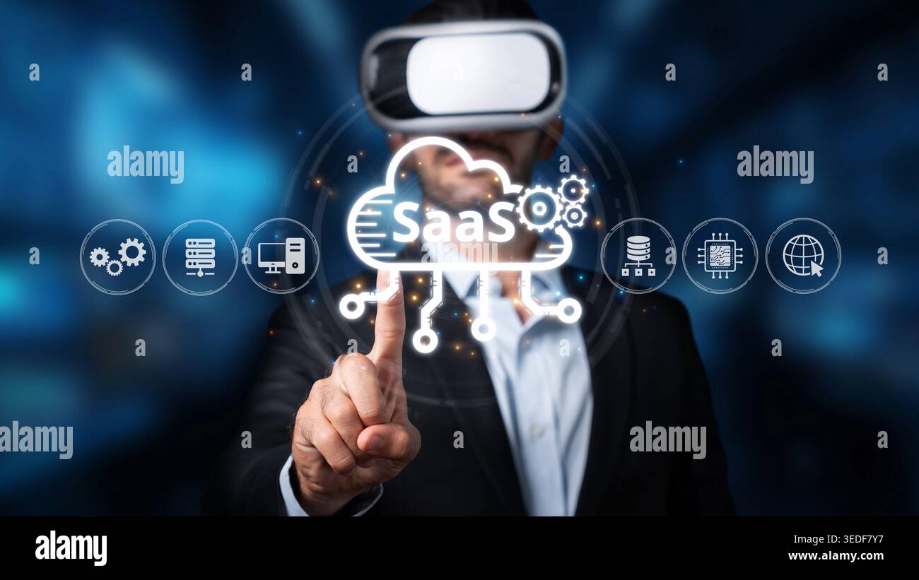 A businessman wears a virtual reality headset while interacting with cloud technology icons that signify software as a service in a contemporary Stock Photo