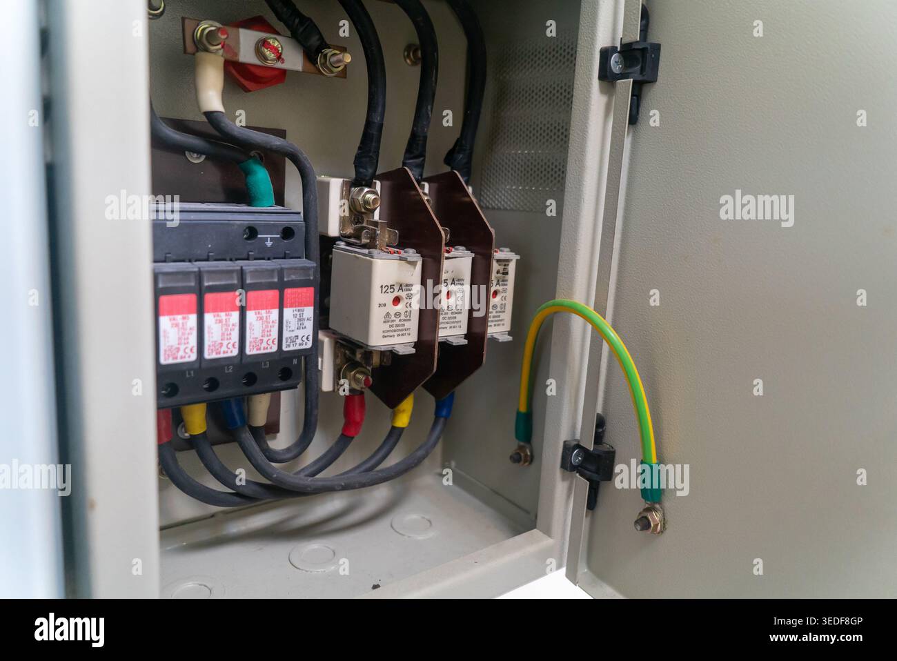 Close-up view of electrical components inside a control panel. The image features circuit breakers and wiring, showcasing installation and electrical Stock Photo