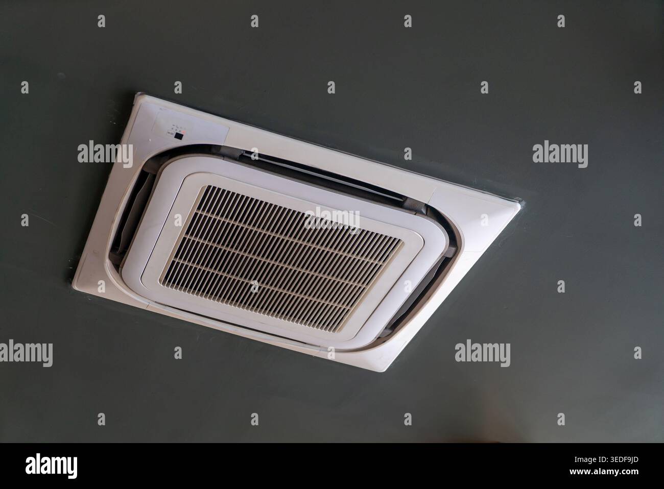 This image showcases a sleek ceiling-mounted air conditioning unit, highlighting its modern design and functionality for indoor climate control. Stock Photo