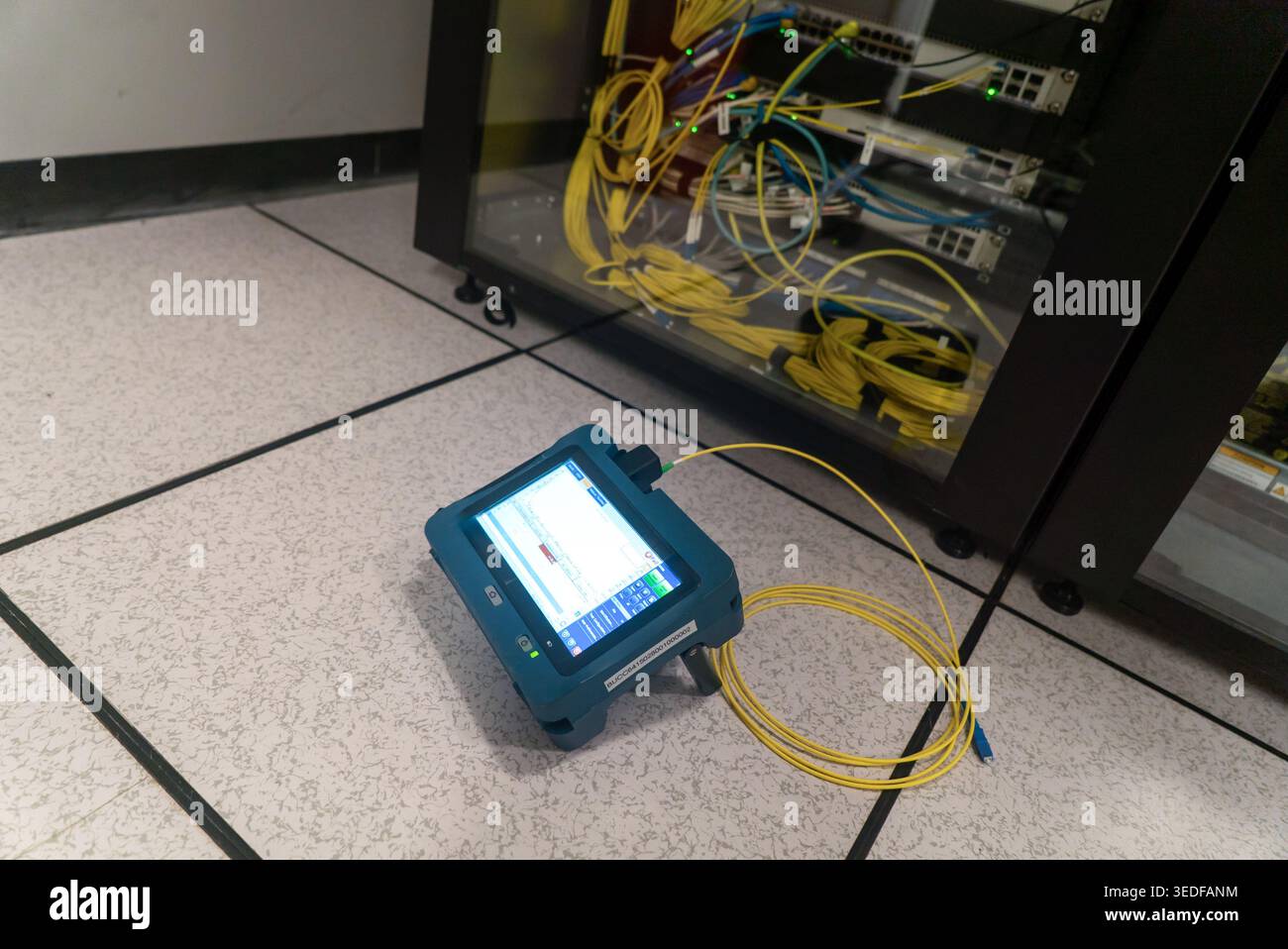 Testing Optical Network A fiber optic testing device is showcased in a modern data center ...