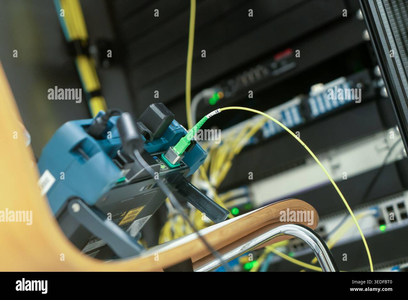 This image showcases high-tech network equipment and cables in a server room, emphasizing connectivity and modern technology in data communication sys Stock Photo