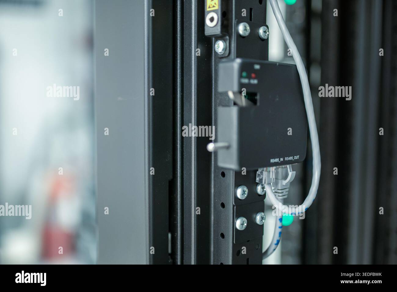 This close-up image showcases advanced network equipment within a server room, highlighting essential connections and technology for efficient data ma Stock Photo