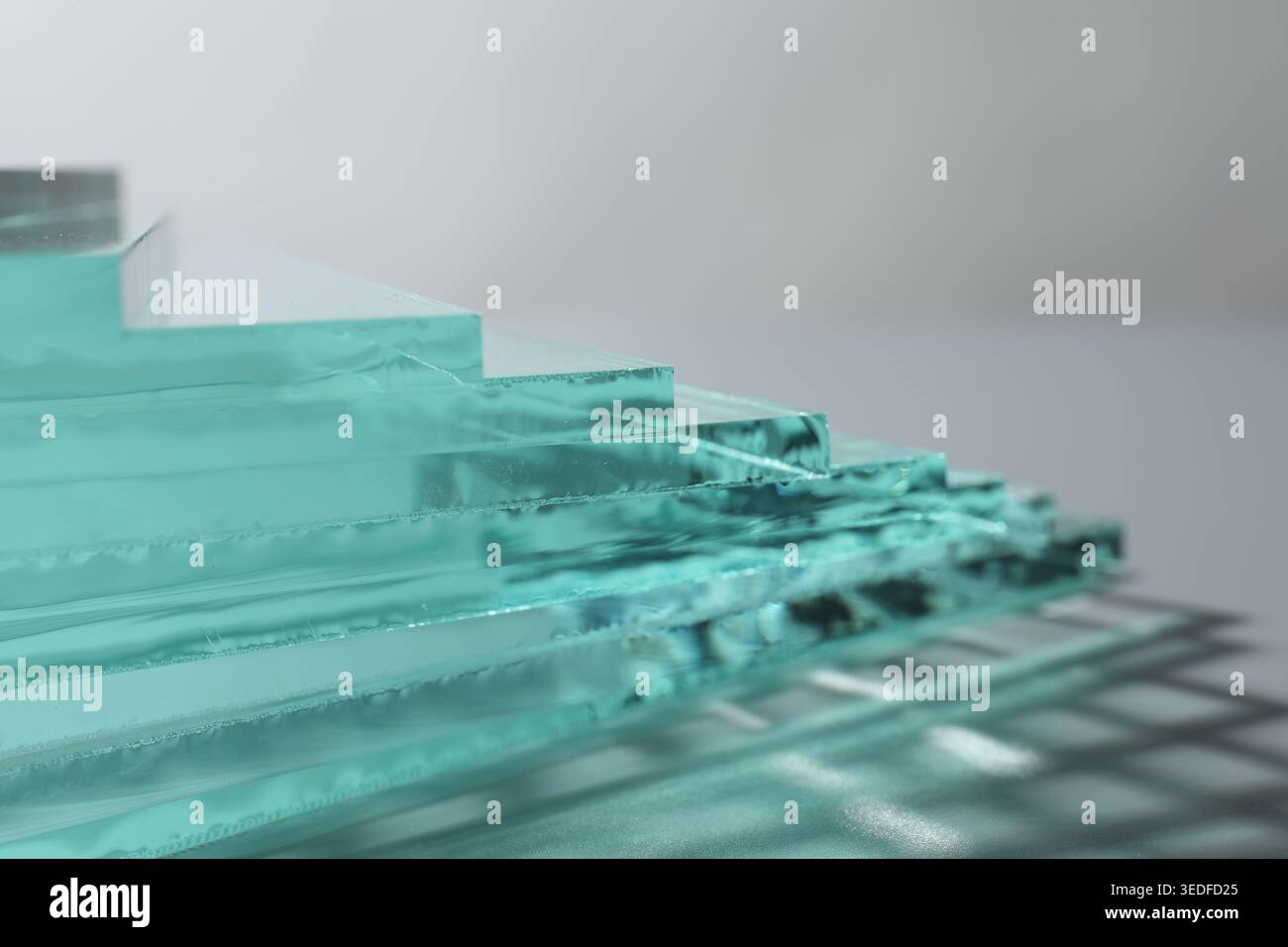 Stack of glass sheets on light background, closeup Stock Photo