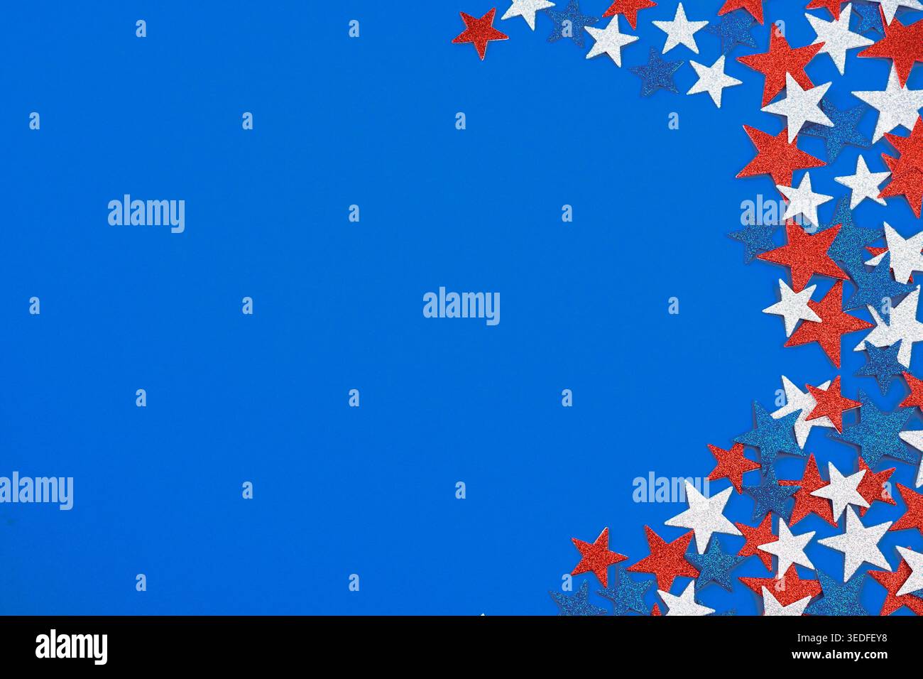 Red white and blue glitter stars on blue background Stock Photo