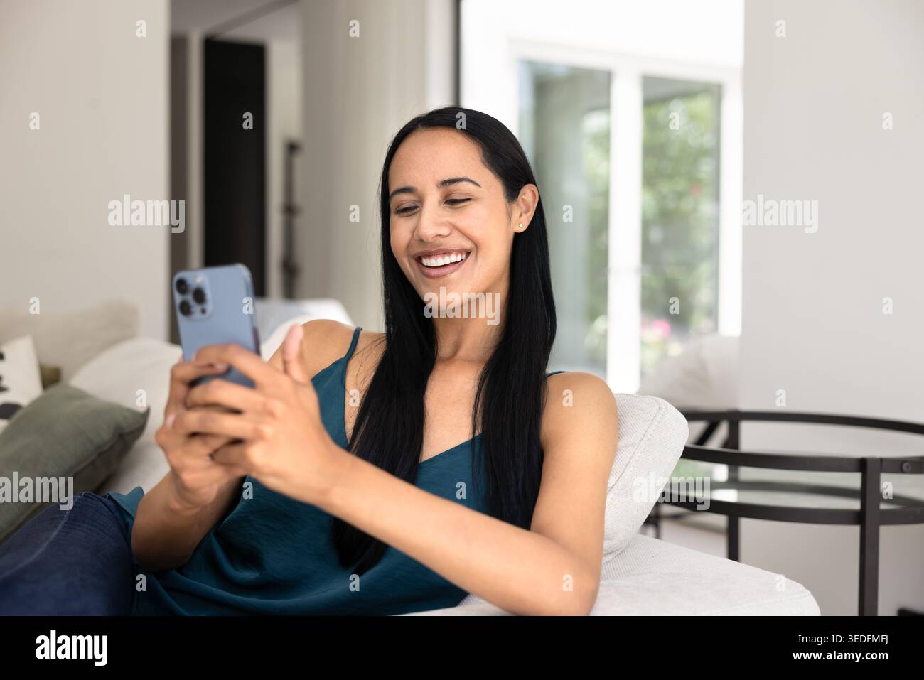 Pretty woman using smartphone gadget at home Stock Photo
